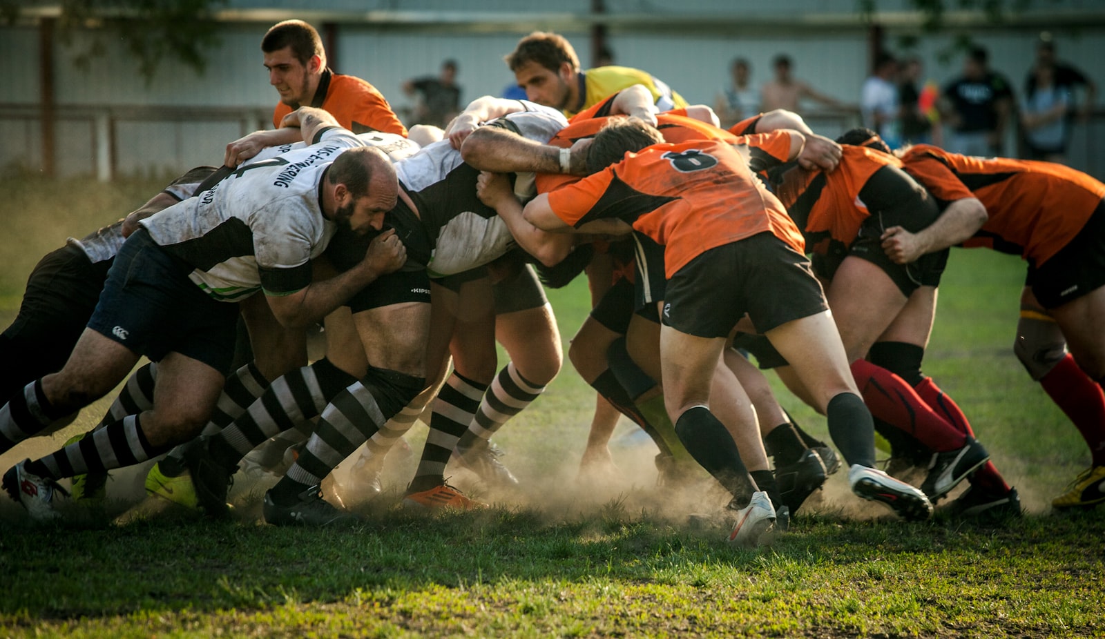 Two packs of rugby players forming a scrum