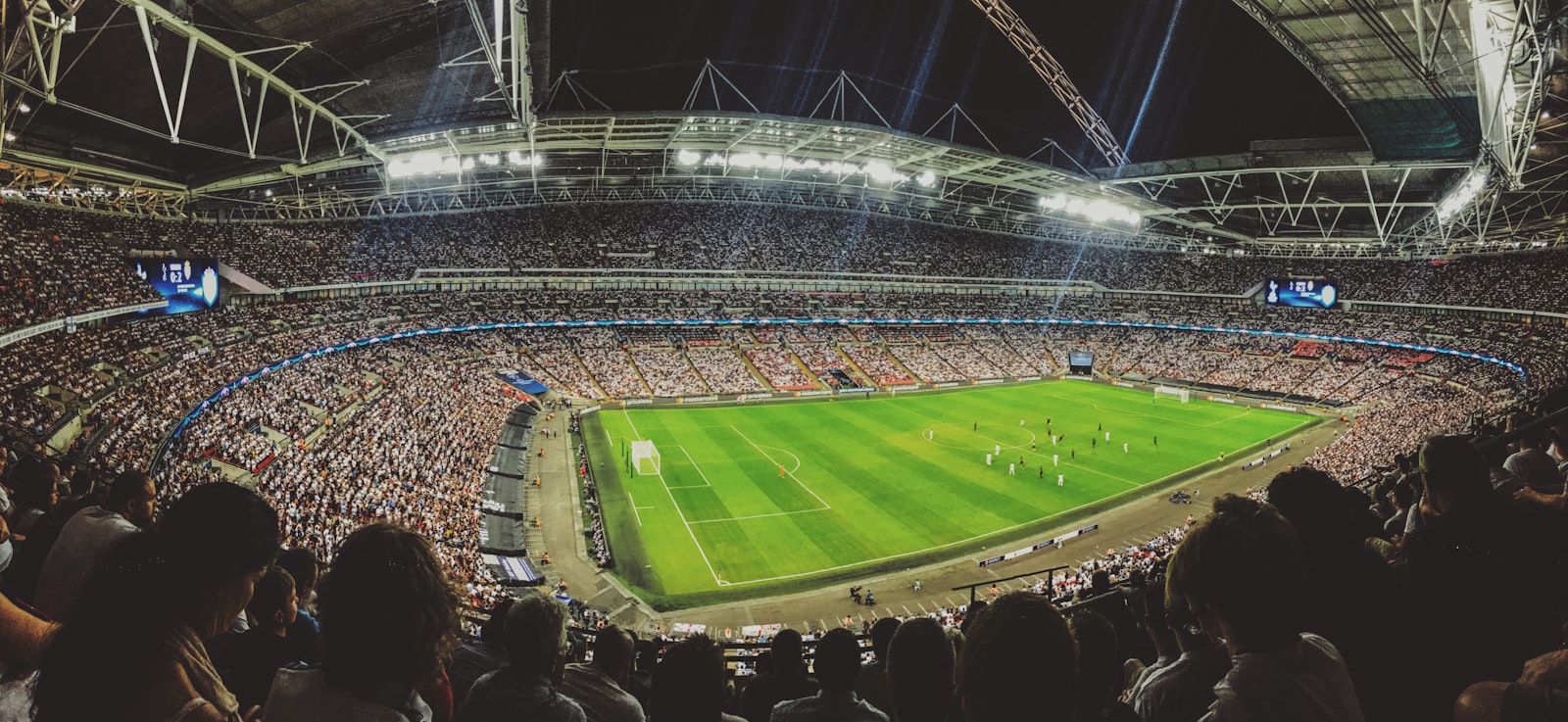 Wembley Stadium under floodlights during a football match