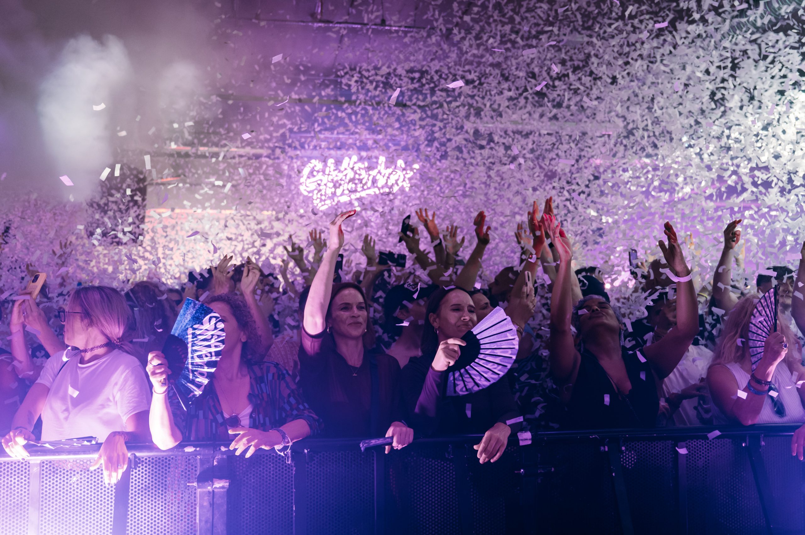 Crowd in the Glitterbox Y Room at Drumsheds under confetti and purple lighting