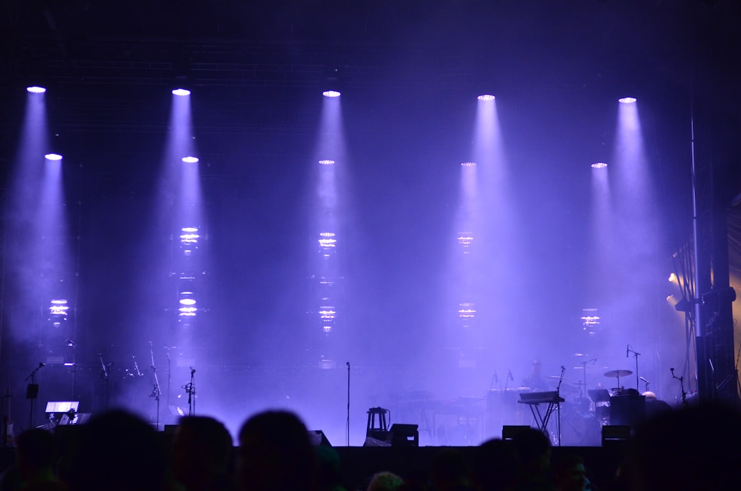 Illustrative live concert stage with purple lighting and haze